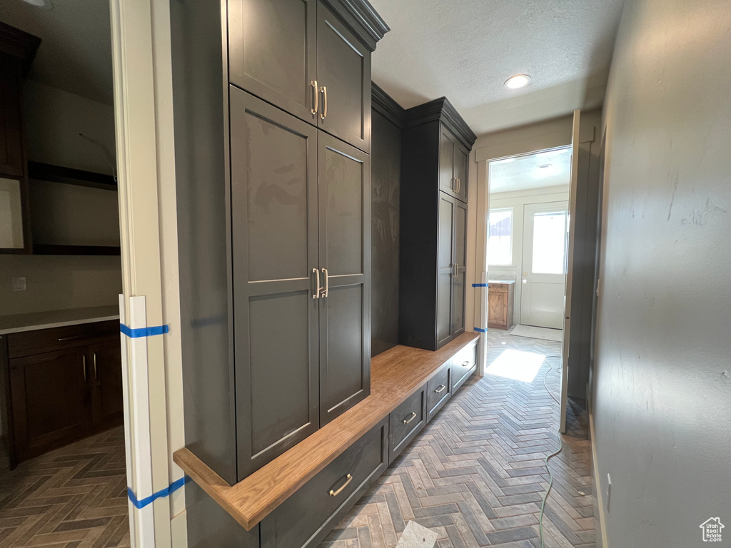 Mudroom featuring recessed lighting and a textured ceiling