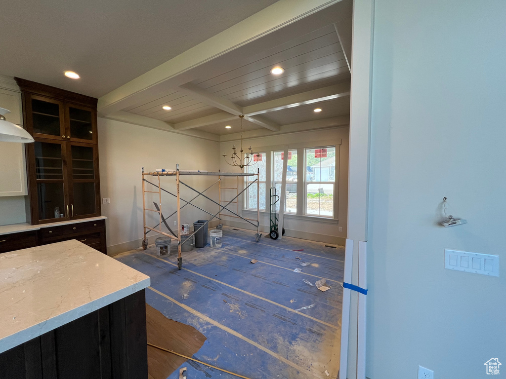 Interior space with beamed ceiling, recessed lighting, and baseboards