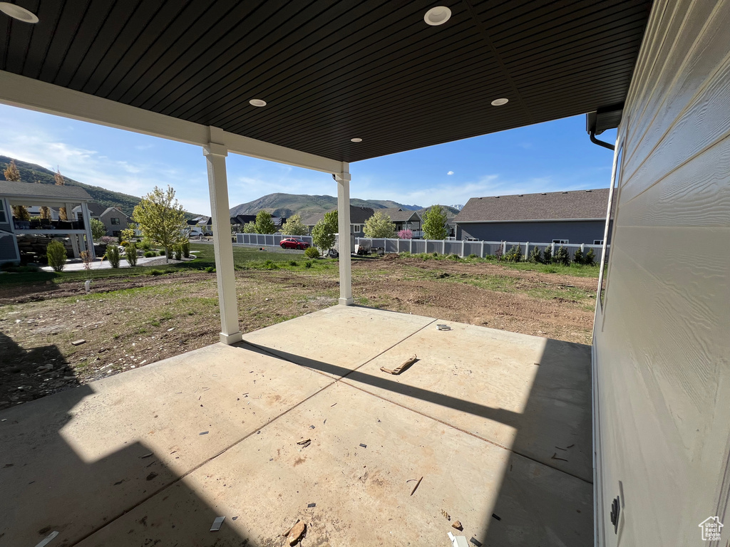 View of patio / terrace featuring a mountain view and fence