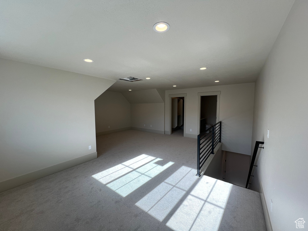 Bonus room featuring recessed lighting, light carpet, and baseboards