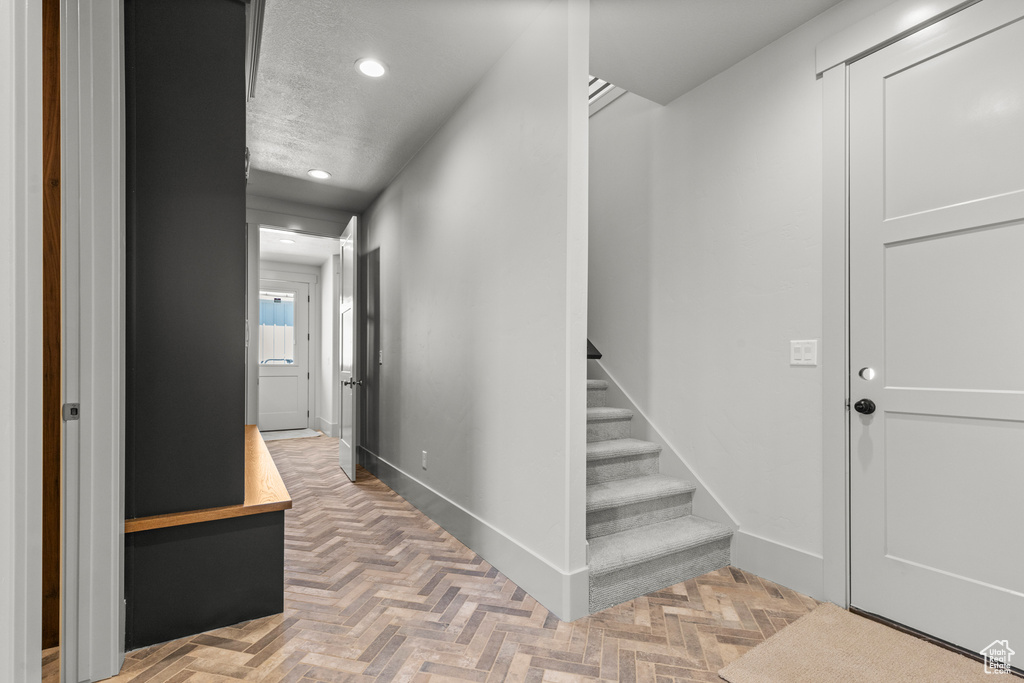 Hall featuring recessed lighting and stairs