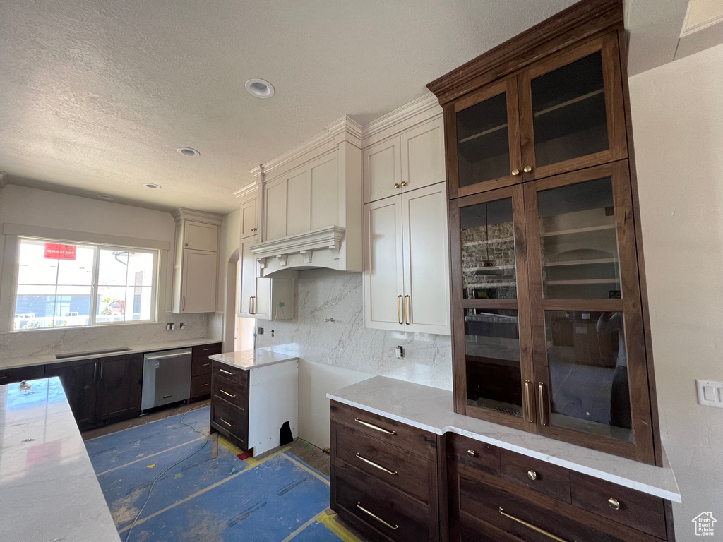 Kitchen featuring dishwasher, tasteful backsplash, dark brown cabinetry, light countertops, and recessed lighting
