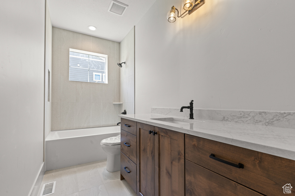 Bathroom with vanity and shower / bath combination