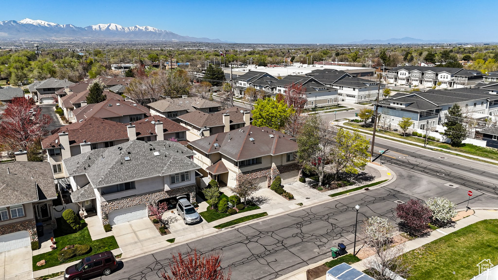 Birds eye view of property with a mountain view and a residential view