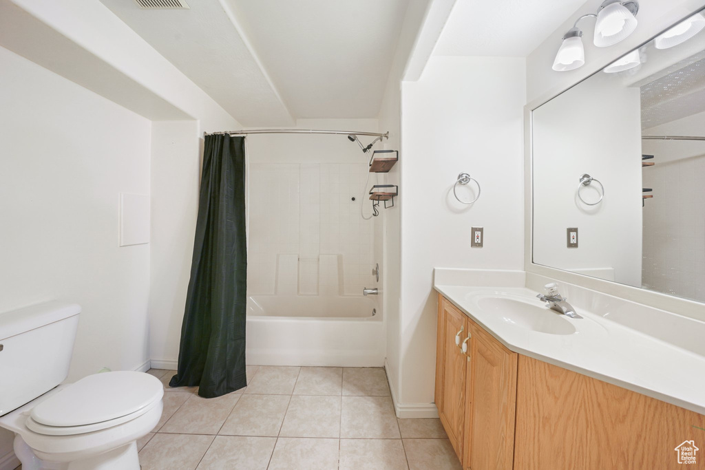 Bathroom with visible vents, toilet, shower / bathtub combination with curtain, vanity, and tile patterned floors
