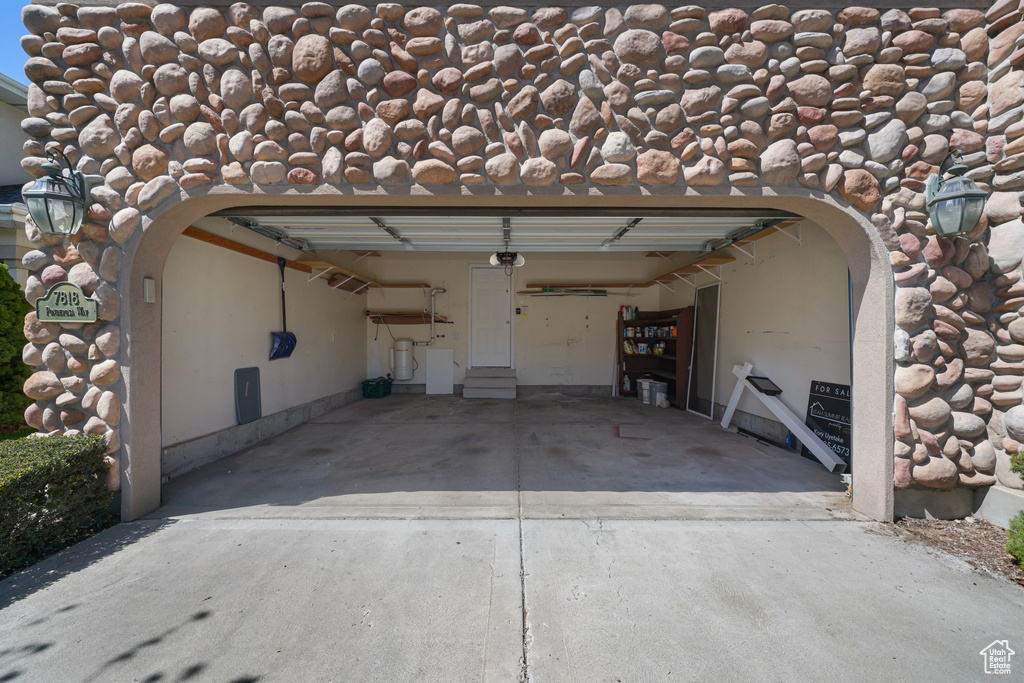 Garage with a garage door opener and concrete driveway