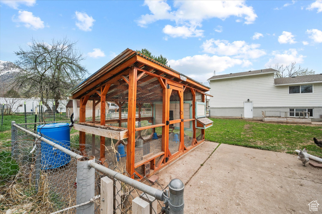 View of patio with fence, an outdoor structure, and exterior structure