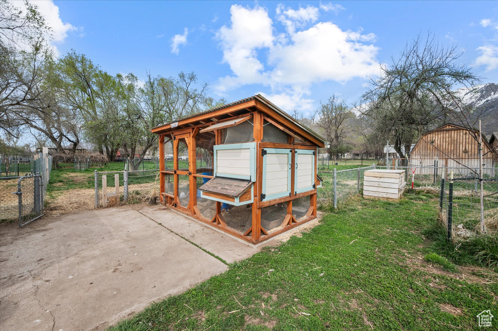 View of poultry coop with a yard and fence