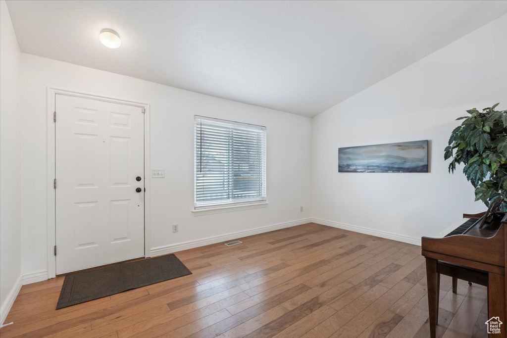 Foyer entrance featuring baseboards and light wood-style floors