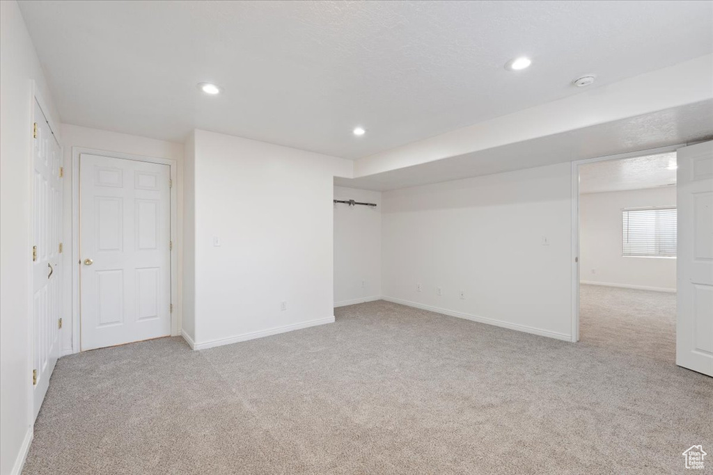 Interior space featuring baseboards, recessed lighting, and carpet