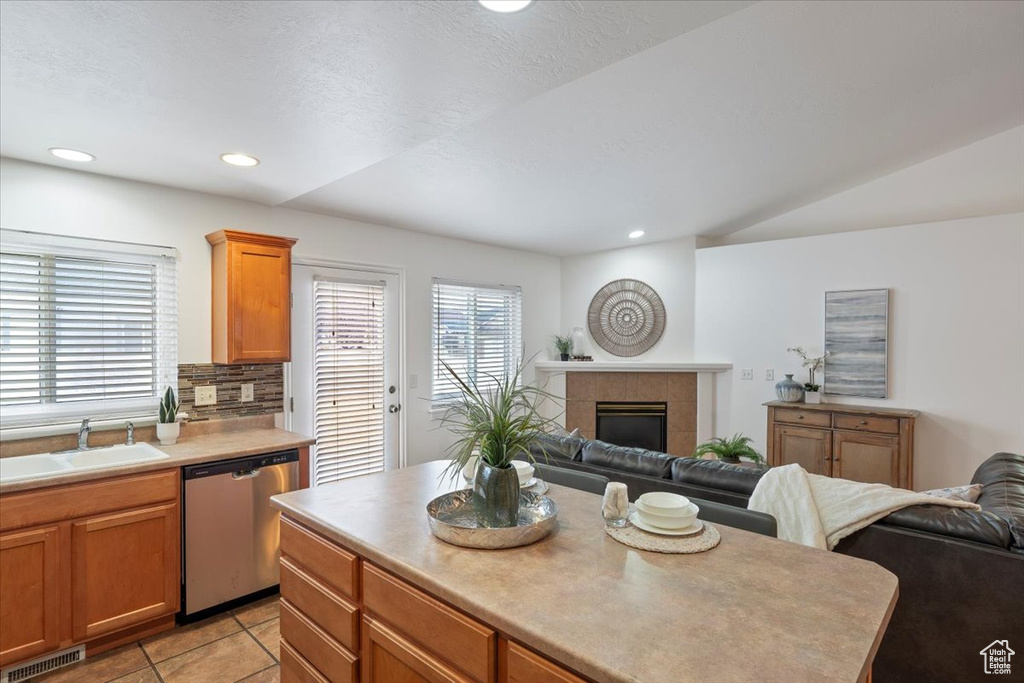 Kitchen with a sink, visible vents, open floor plan, and dishwasher