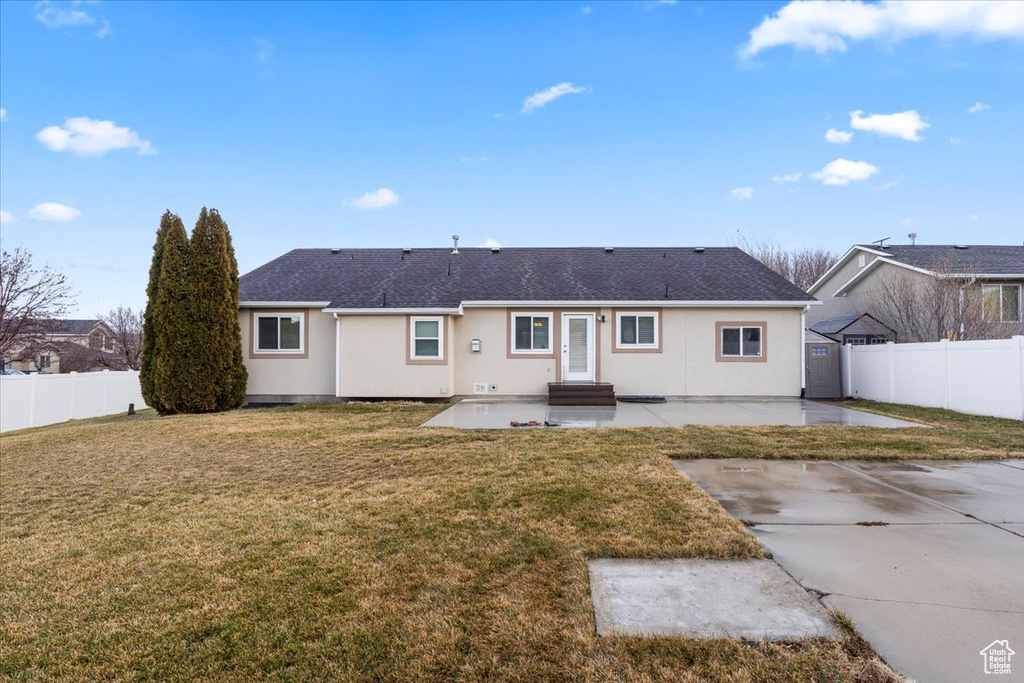Rear view of property with a yard, a fenced backyard, a patio, entry steps, and roof with shingles