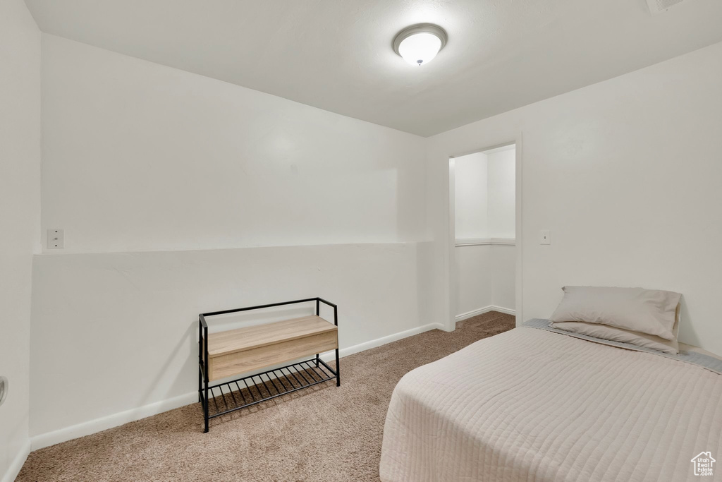 Carpeted bedroom with baseboards