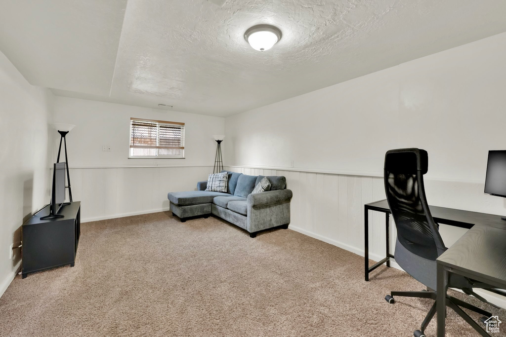 Carpeted office with a textured ceiling