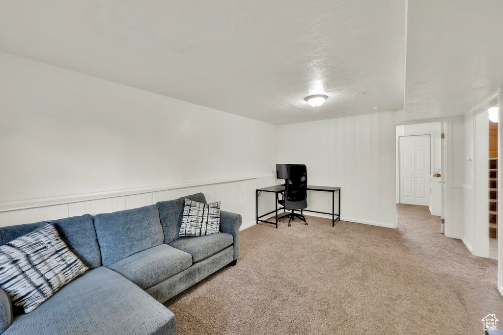 Carpeted living area with baseboards