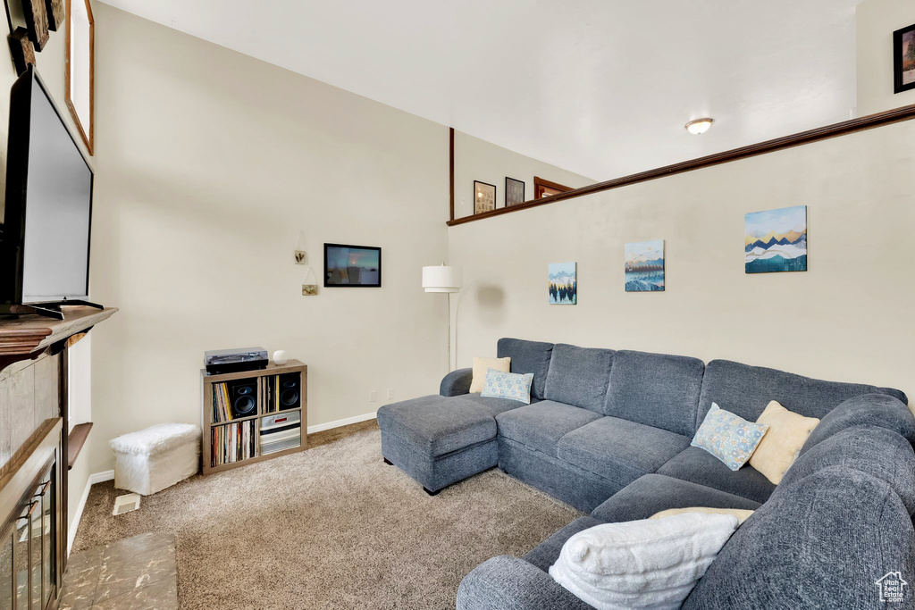 Carpeted living area with baseboards