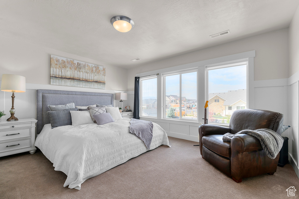 Carpeted bedroom featuring visible vents