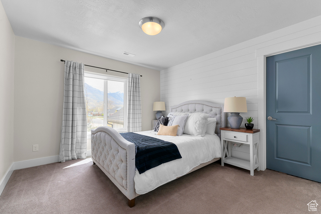 Bedroom featuring visible vents, baseboards, and carpet floors