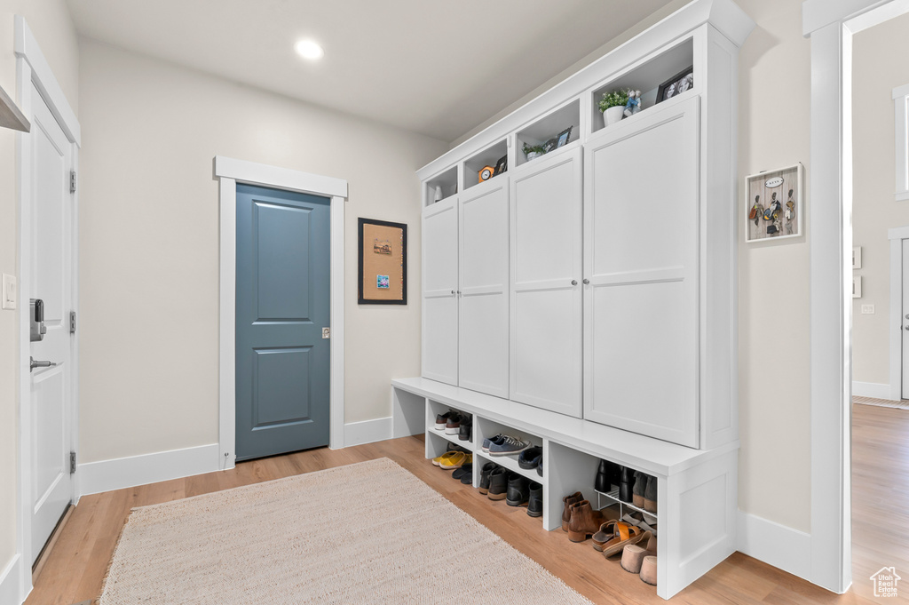 Mudroom with recessed lighting, light wood-style flooring, and baseboards