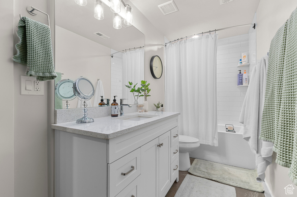 Full bathroom featuring visible vents, toilet, shower / tub combo, and vanity