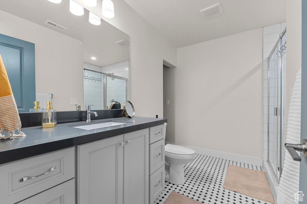 Bathroom with visible vents, toilet, a shower stall, vanity, and tile patterned flooring