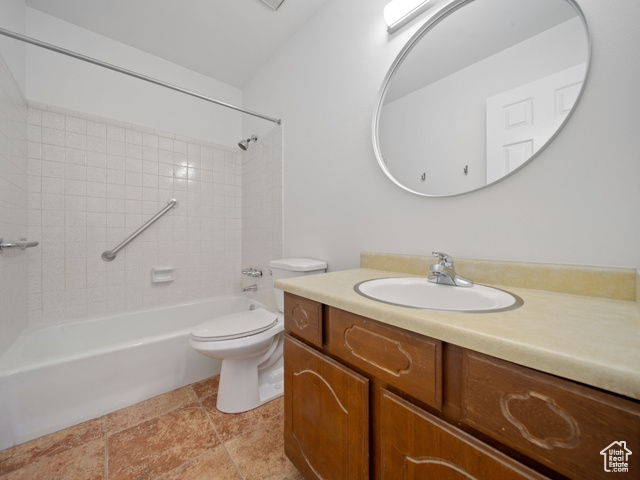 Full bathroom featuring toilet, vanity, and tub / shower combination