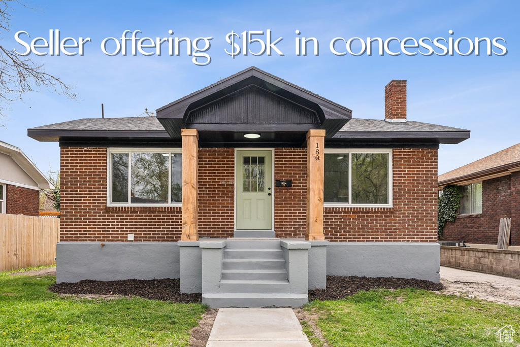 Bungalow featuring brick siding and a chimney