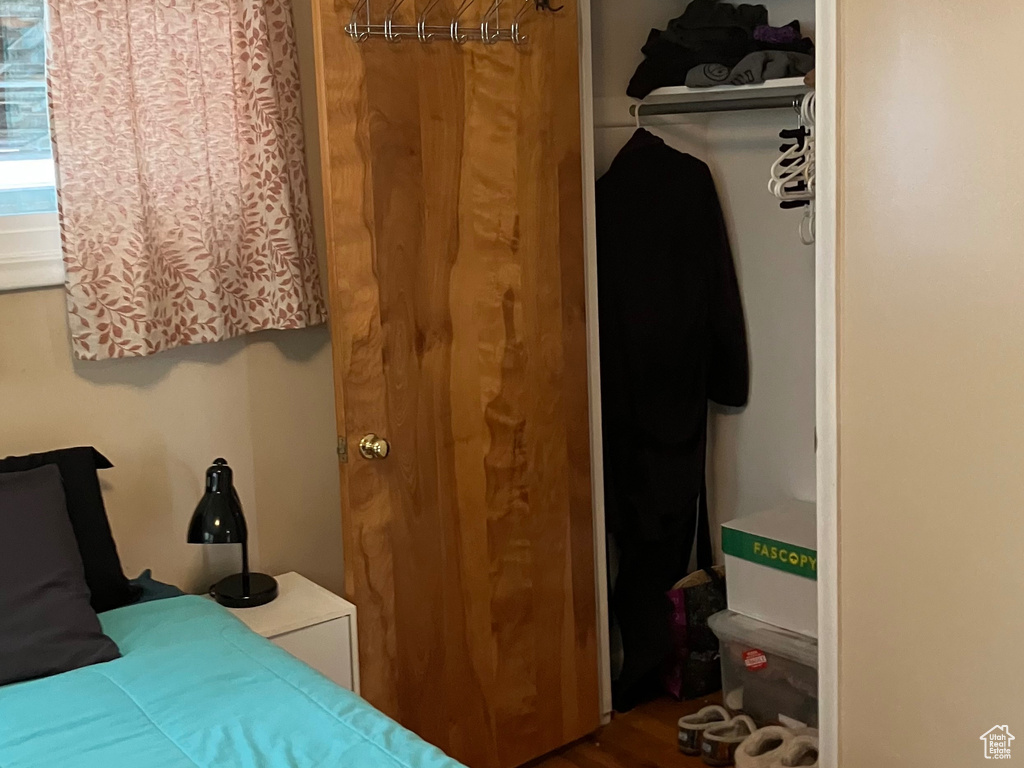Bedroom with a closet, baseboards, and wood finished floors