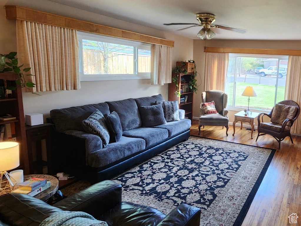 Living area with a ceiling fan and wood finished floors