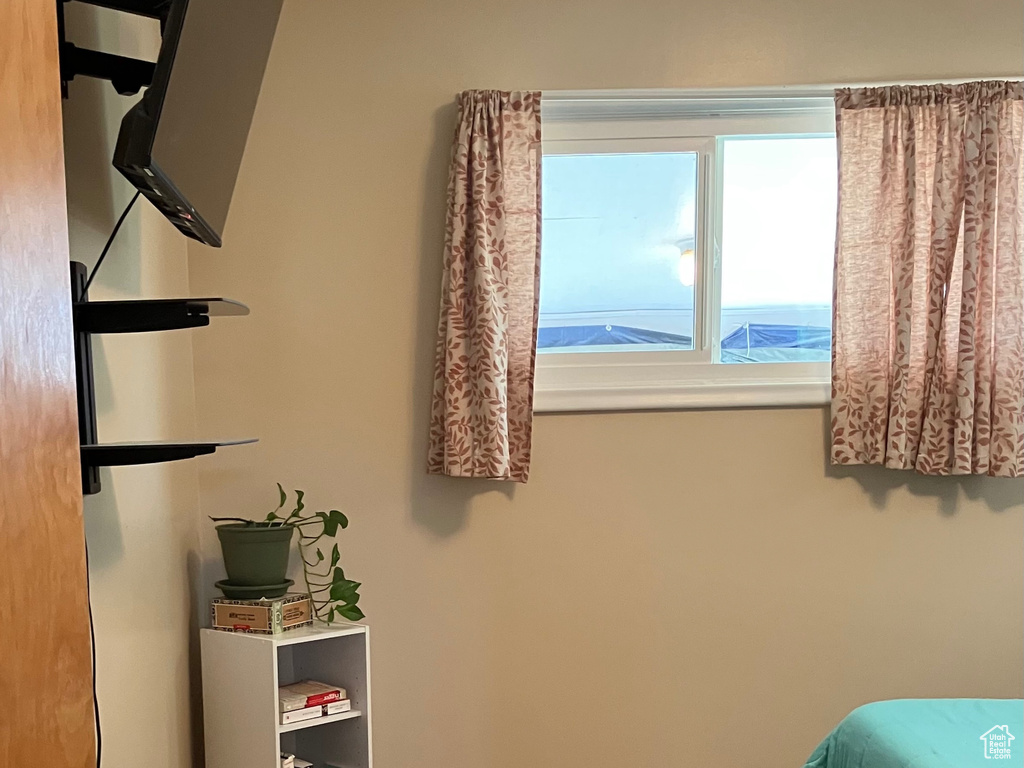 Bedroom with wood finished floors and baseboards