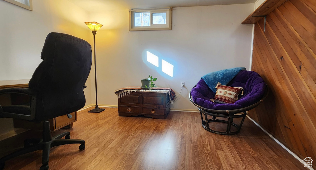 Home office with baseboards and wood finished floors
