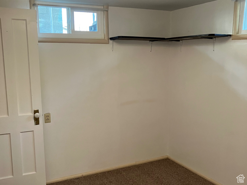 Interior space featuring baseboards and carpet floors