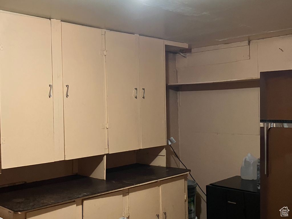 Basement with black fridge