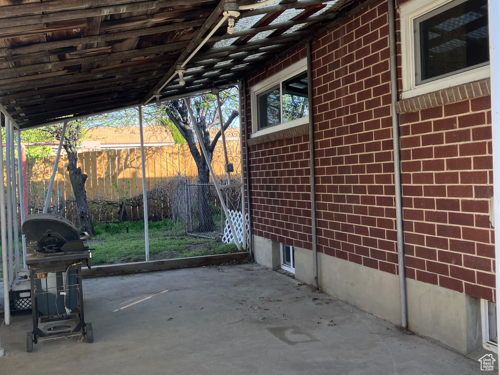 View of patio featuring fence