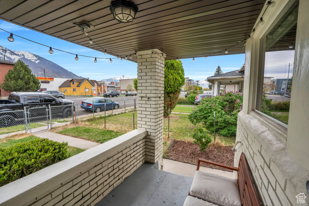View of patio with fence, a gate, and a residential view