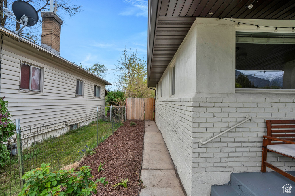 View of home\\\'s exterior featuring fence and a chimney