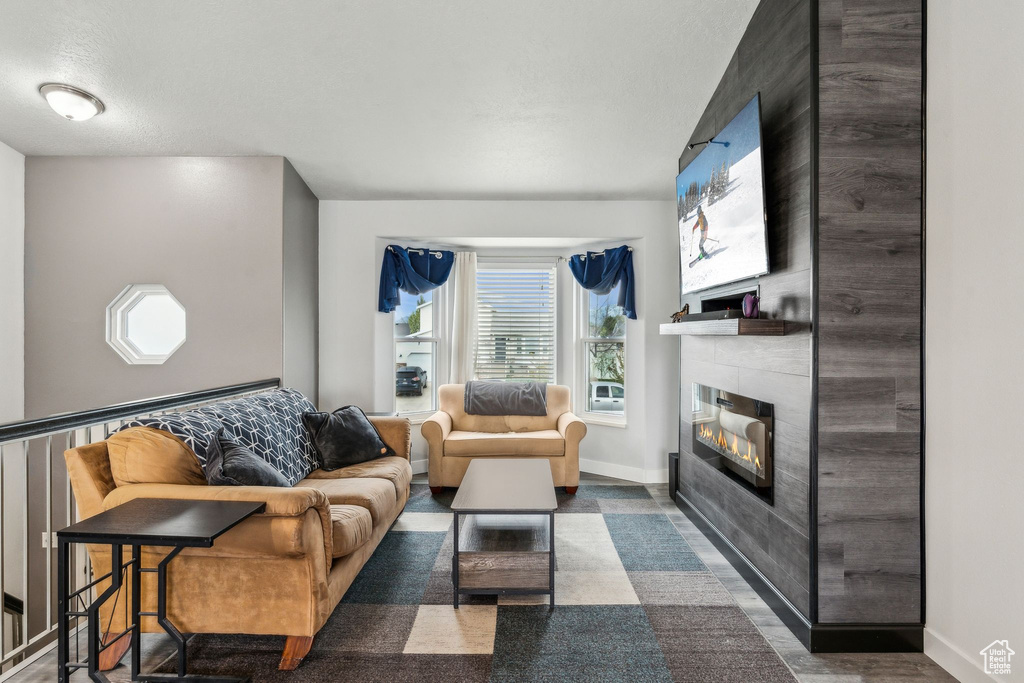 Living area featuring baseboards and a fireplace