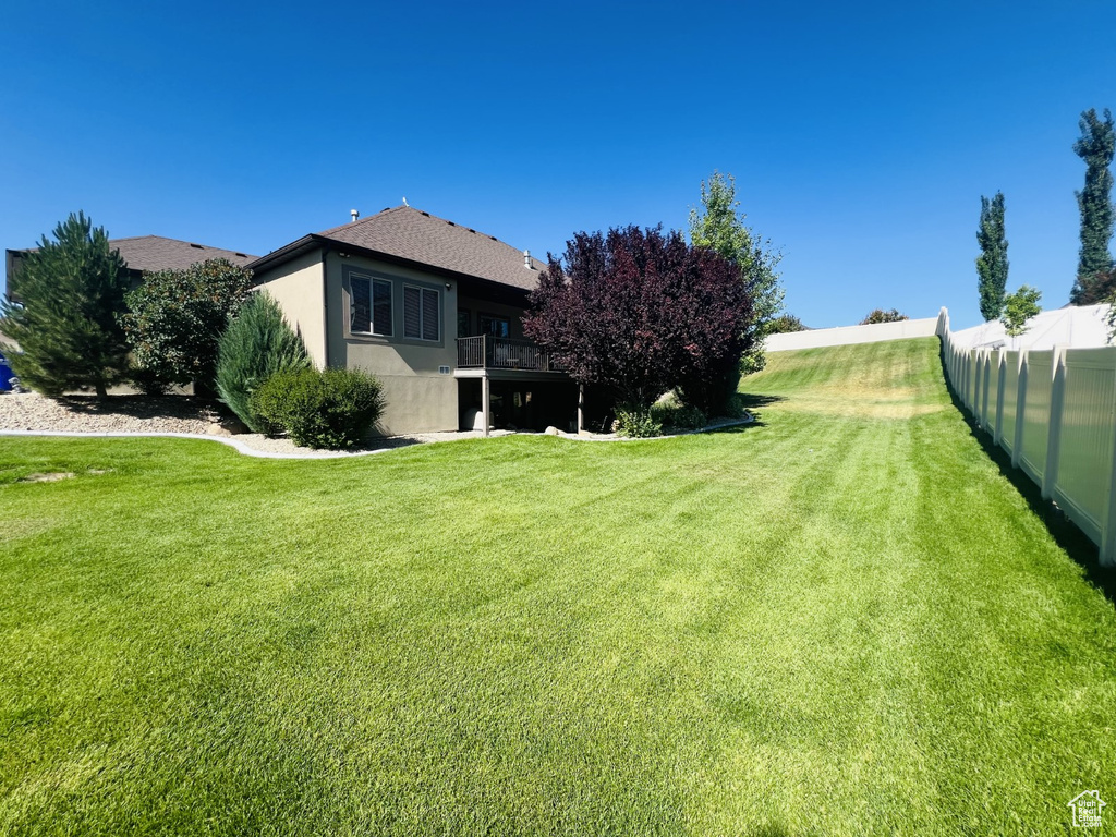 View of yard with a balcony