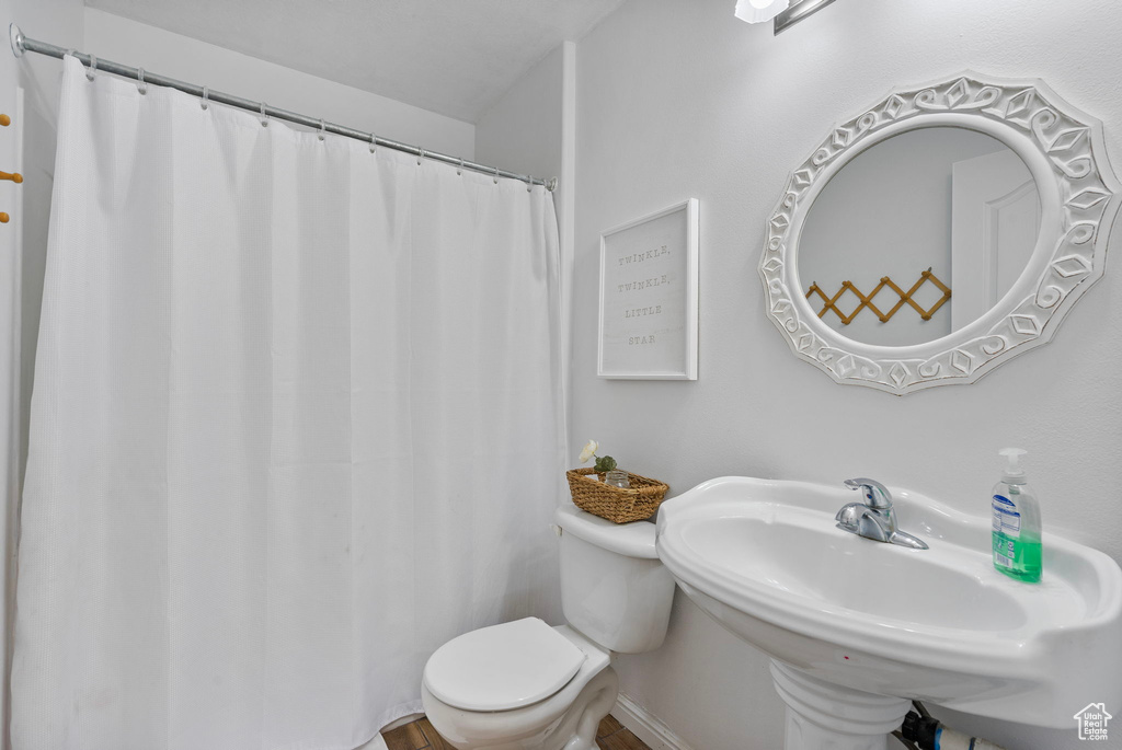 Full bath with toilet and a sink