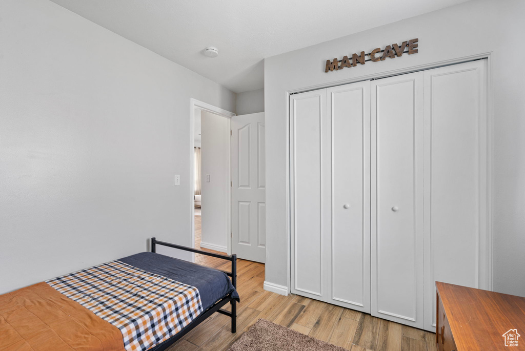 Bedroom featuring light wood-type flooring and a closet