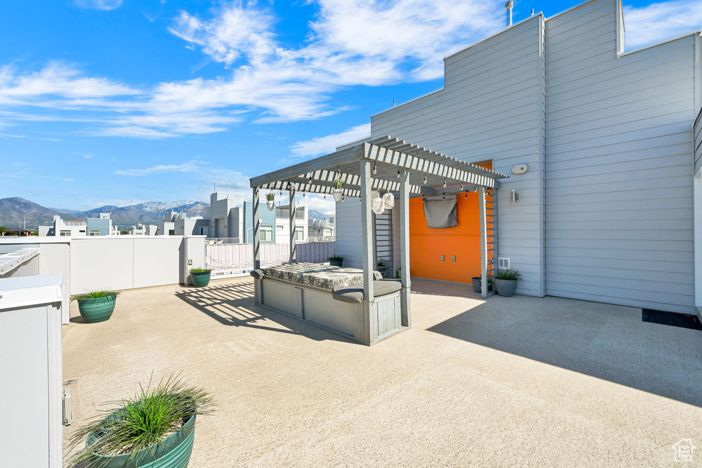 View of patio featuring a pergola, a mountain view, and fence