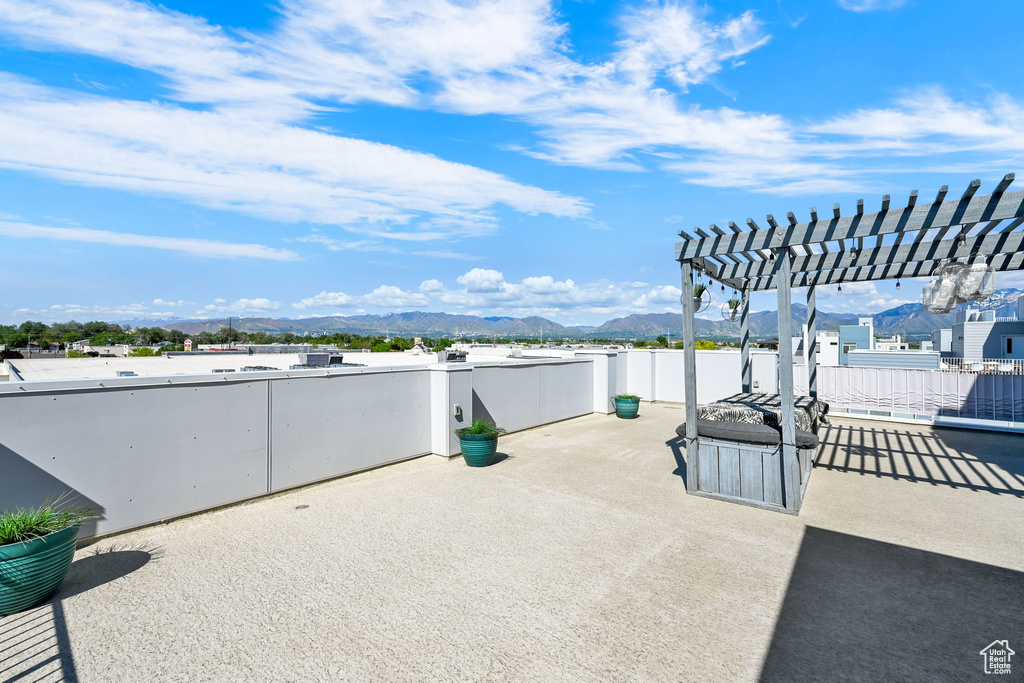 View of patio featuring a pergola and a mountain view