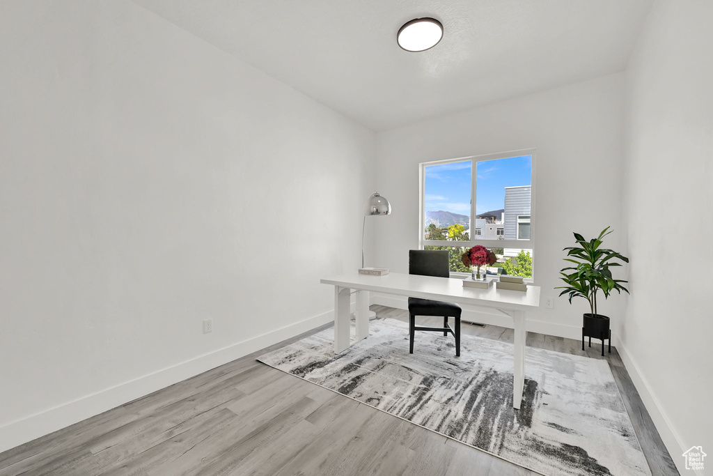 Office with baseboards and wood finished floors