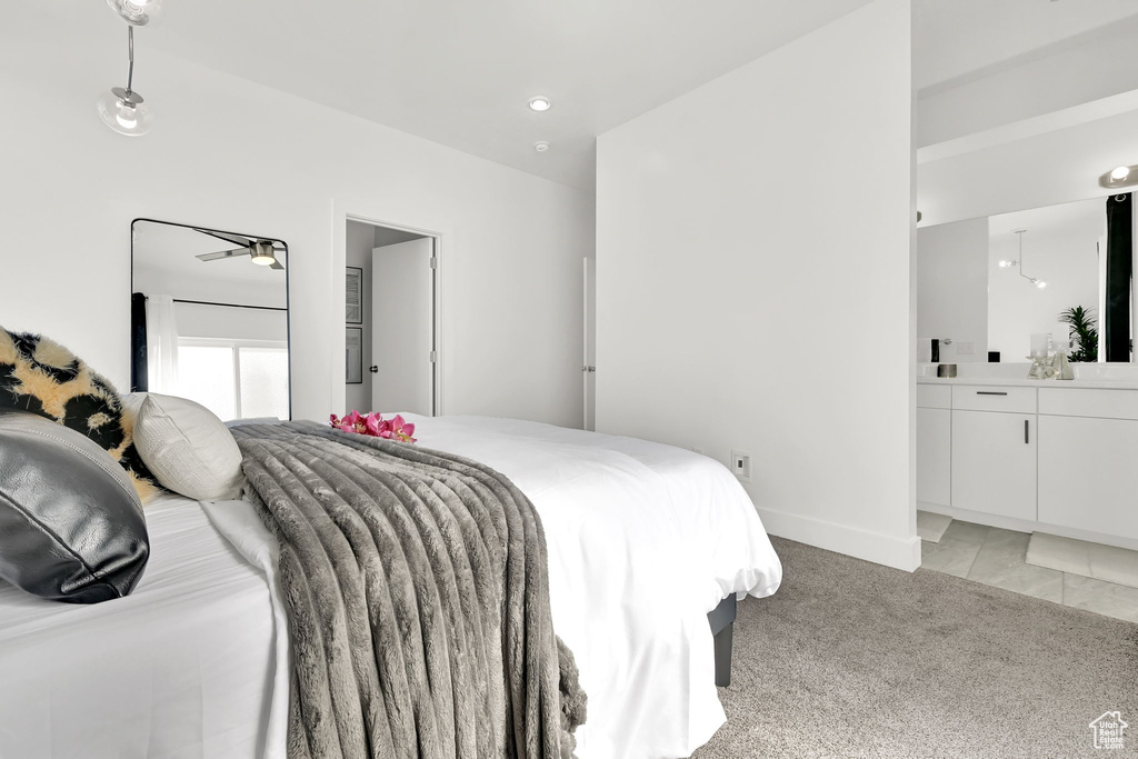Bedroom featuring light colored carpet and baseboards
