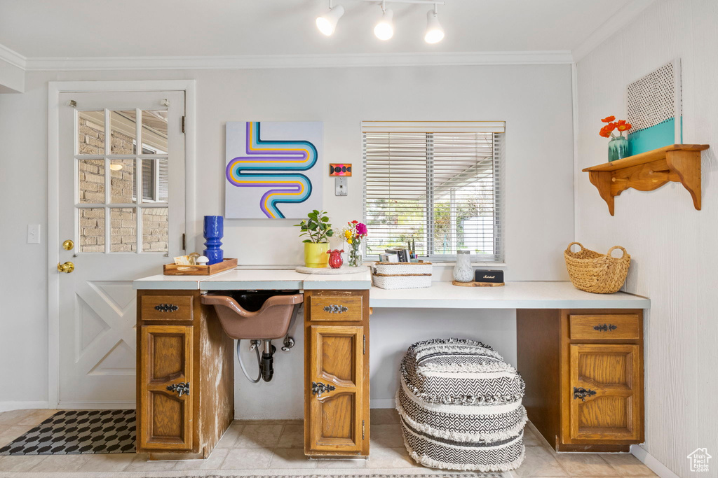 Office area with built in study area and crown molding