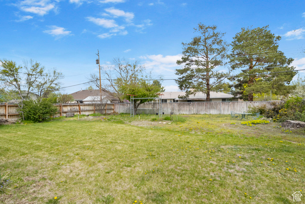 View of yard featuring fence