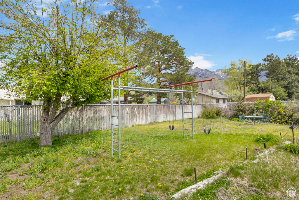 View of yard with fence and a mountain view
