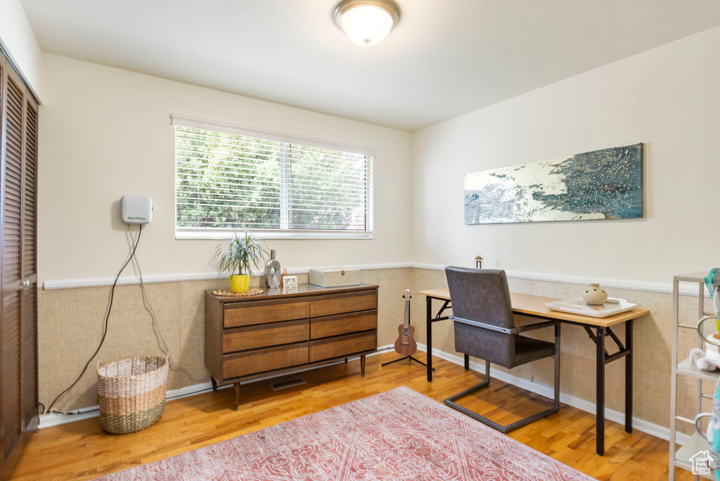 Office area with wainscoting and wood finished floors