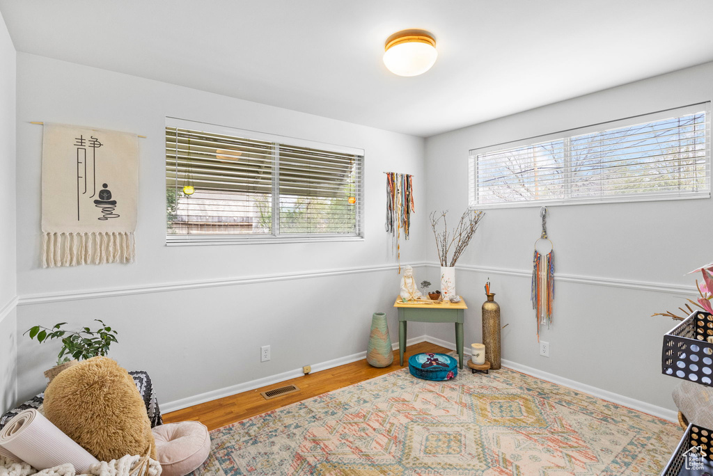 Game room featuring baseboards, wood finished floors, and visible vents