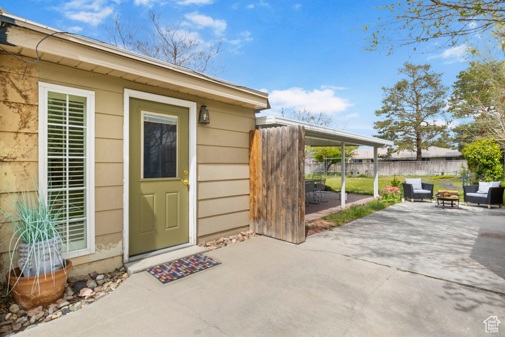 Doorway to property with fence and a patio